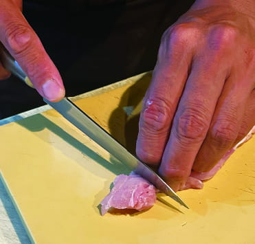 Cutting chicken for yakitori
