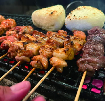 Grilling yakitori over charcoal
