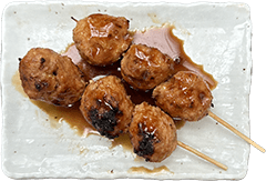 Tsukune yakitori skewer made from seasoned minced chicken in Kobe, Japan
